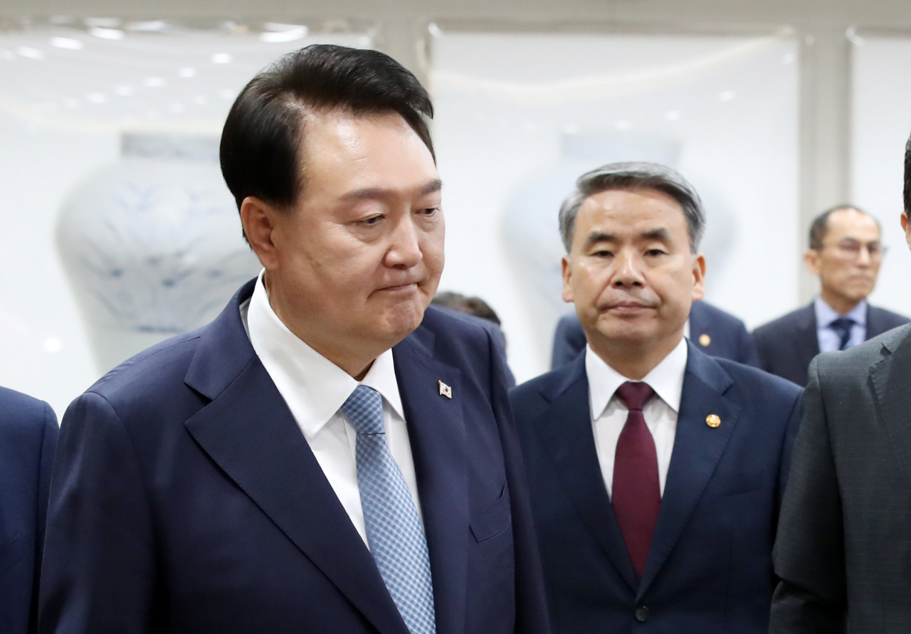 President Yoon Suk Yeol (left) enters a Cabinet meeting at the presidential office on Tuesday. (Yonhap)