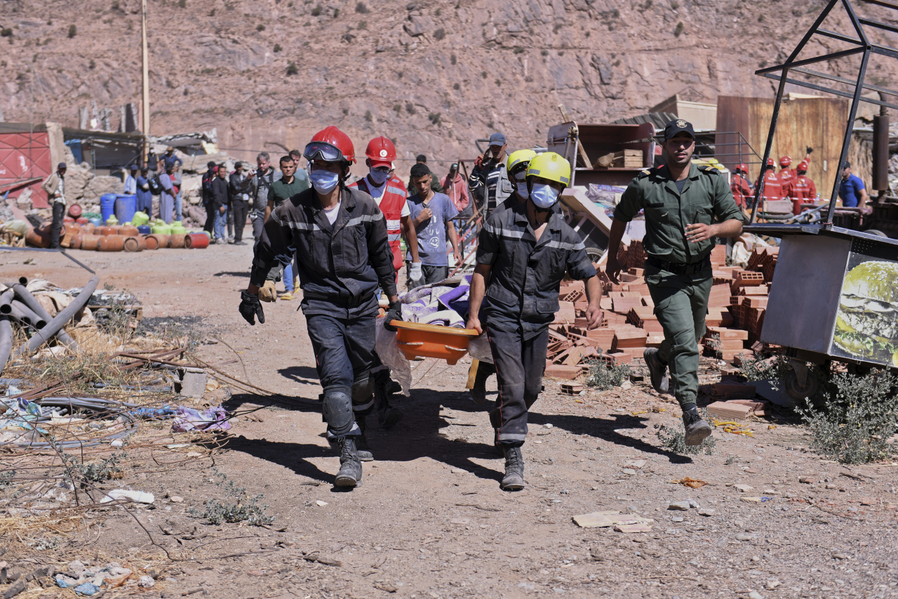 This AP photo shows a victim being carried away by rescue workers in Talat N'yakoub, Morocco, on Sept. 11. (Yonhap)