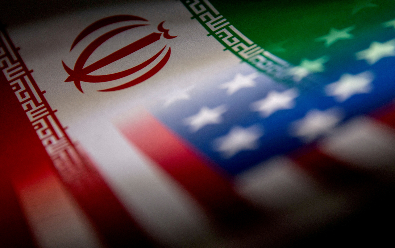 The Iranian and US flags are seen printed on paper in this illustration taken January 27, 2022. (Reuters)