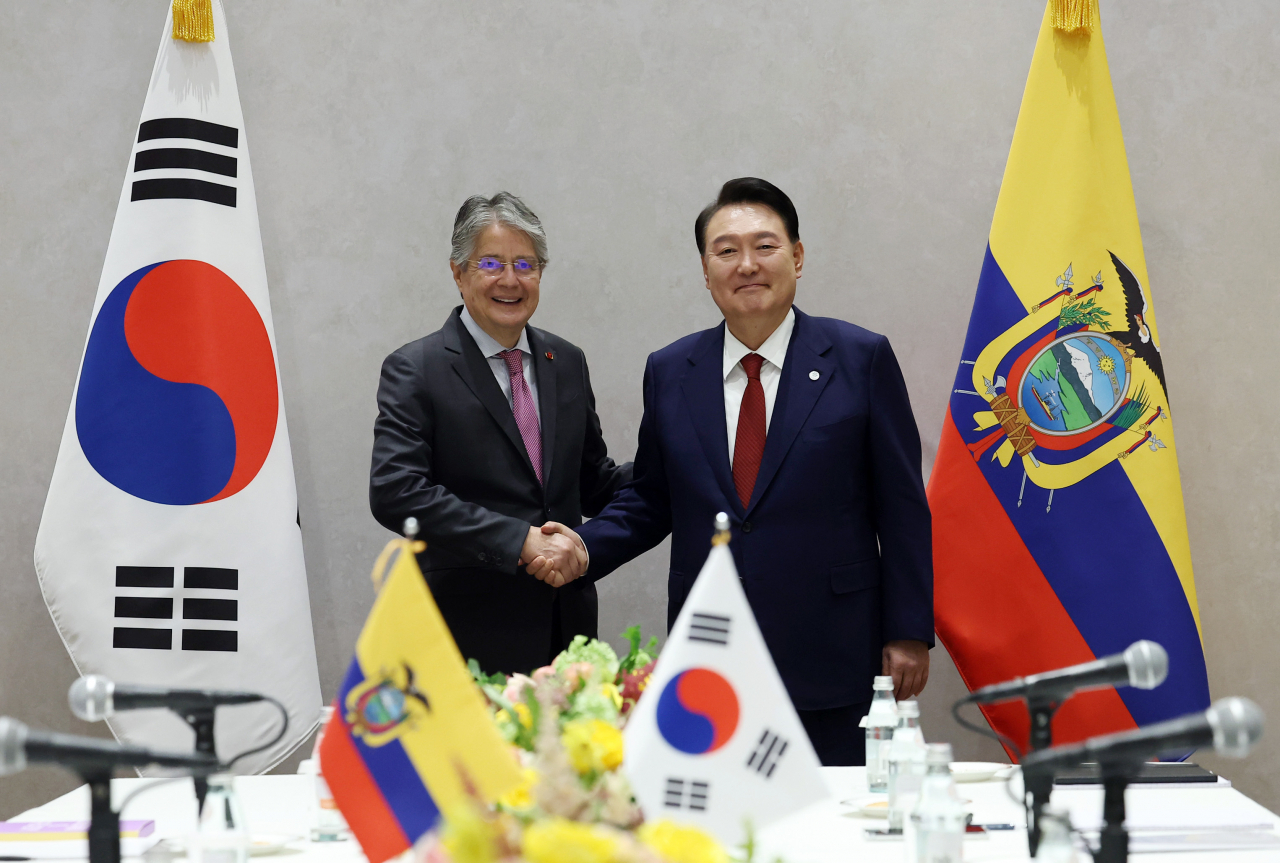 President Yoon Suk Yeol (right) shakes hands with Ecuadorian President Guillermo Lasso during a summit in New York on Thursday. (Yonhap)