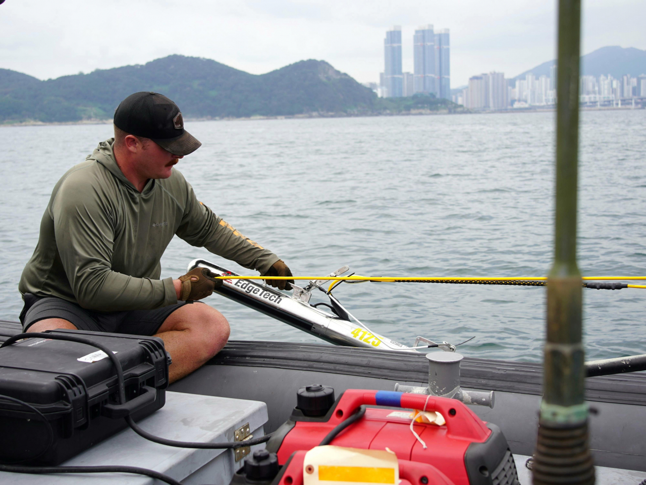 The collaborative South Korea-US team conducts an underwater survey aboard a high-speed boat using Side-Scan Sonar and magnetometer sensors. (Photo courtesy of the Ministry of National Defense Agency for Killed in Action Recovery Identification)