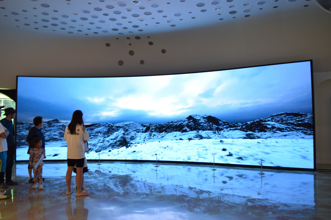 Visitors watch a short film on the ice age. (Kim Hae-yeon/ The Korea Herald)