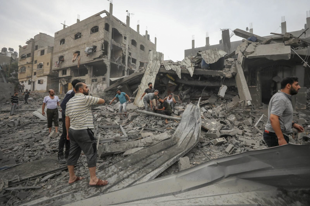 Palestinians search for survivors of Israeli aerial bombing on Jabaliya, near Gaza City, Wednesday. (AP)