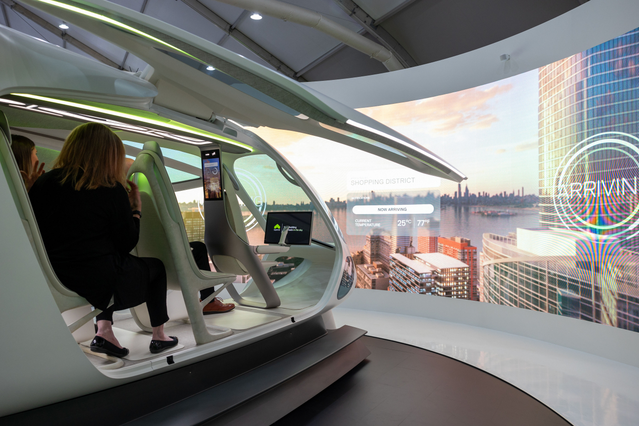 Visitors experience an augmented reality service of an urban air mobility aircraft presented by Hyundai Motor Group’s UAM unit Supernal on Tuesday at the Seoul ADEX 2023 held in Seongnam, Gyeonggi Province. (Hyundai Motor Group)