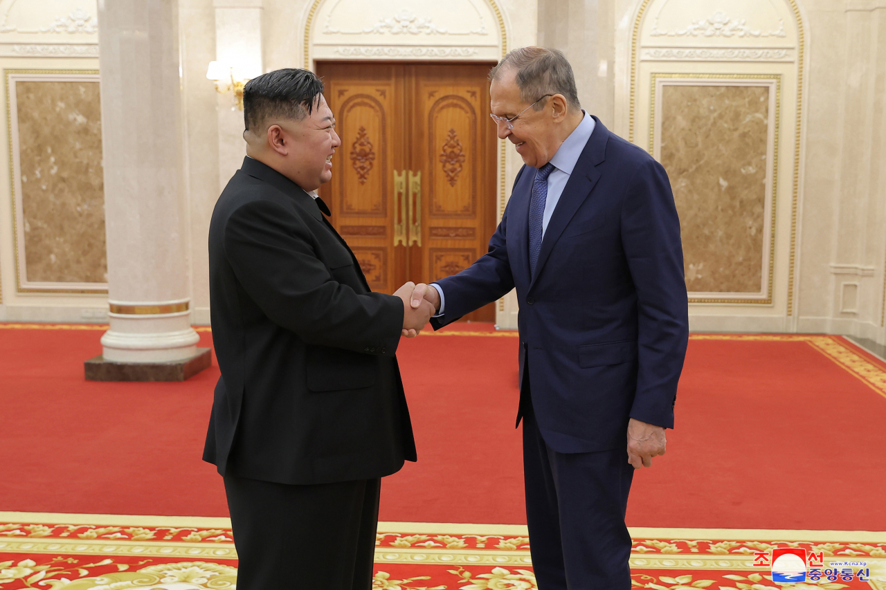 North Korean leader Kim Jong-un (left) shakes hands with Russian Foreign Minister Sergei Lavrov during their meeting in Pyongyang on Oct. 19. (KNCA)