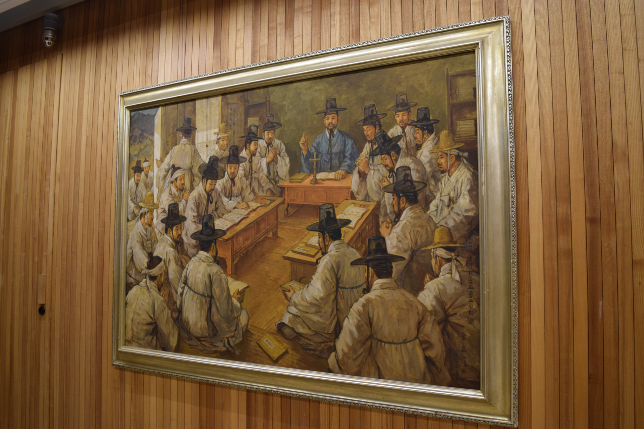 An assembly of early Korean Catholics at Myeongnyeban is depicted in a painting (Kim Hae-yeon/ The Korea Herald)
