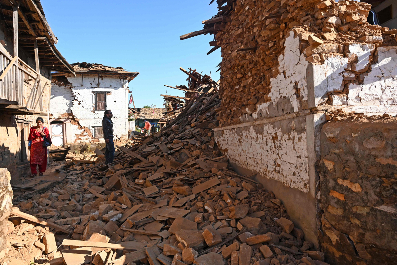 A man looks at damaged houses in the aftermath of an earthquake at Jajarkot district on Saturday. (AFP-Yonhap)