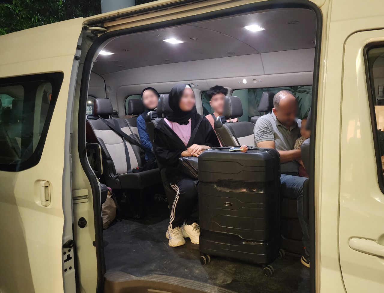 A South Korean family of five members rides in a vehicle to head to a lodging facility in Cairo on Thursday, after crossing into Egypt through the Rafah border from Gaza, amid the armed conflict between Israel and the Islamic militant Hamas group. (Yonhap)