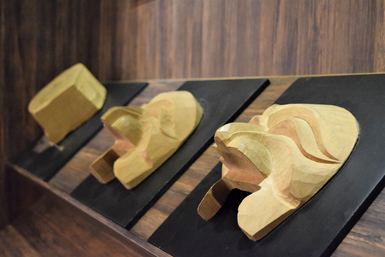 Steps in carving wood to make Hahoetal are on display. (Kim Hae-yeon/The Korea Herald)