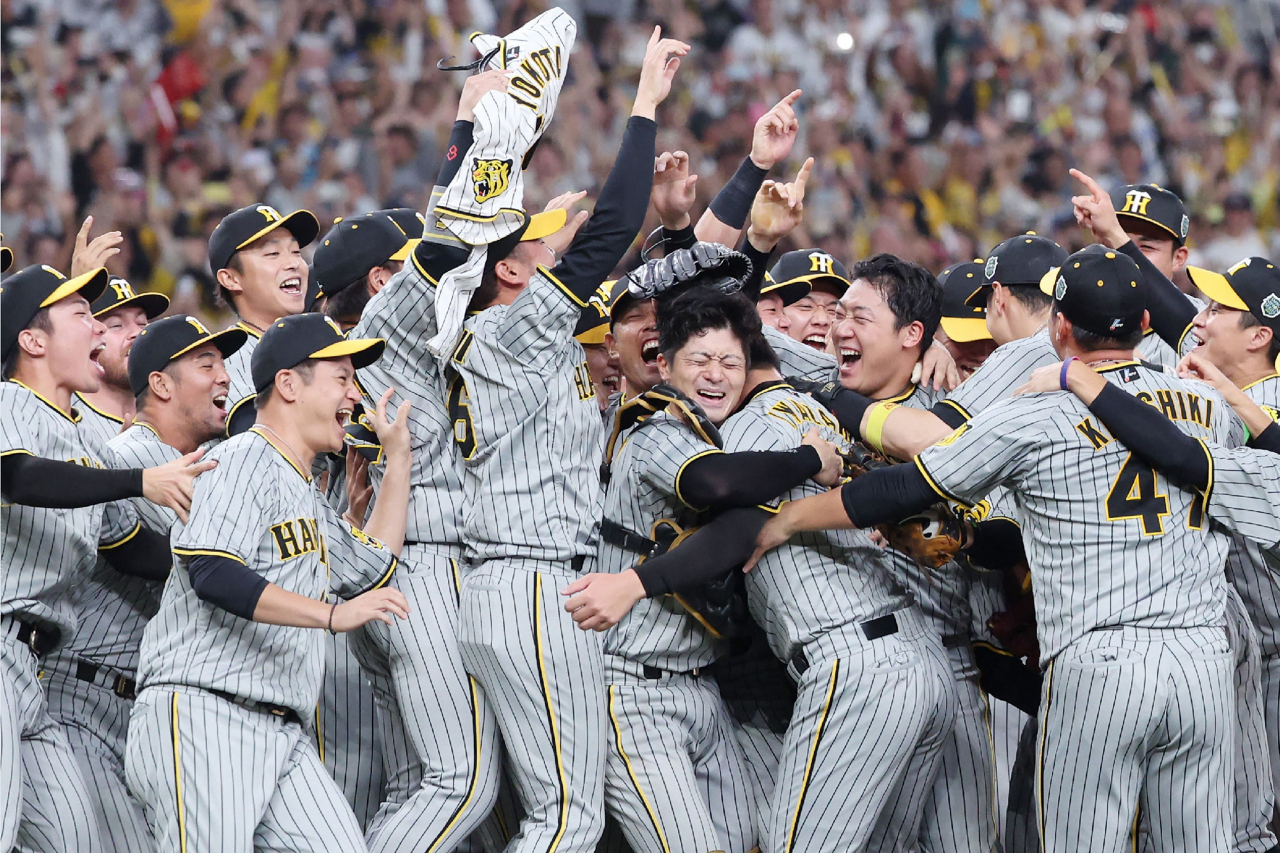 Members of the Hanshin Tigers baseball team celebrate winning the Nippon Series baseball championship for the first time in 38 years after beating the Orix Buffaloes 7-1 in Game 7 of the best-of-seven series, at the Kyocera Dome in Osaka on November 5, 2023. (AFP)