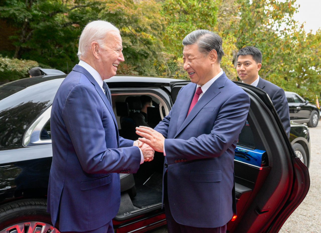 US President Joe Biden escorts Chinese President Xi Jinping to his car to bid farewell after their talks in the Filoli Estate in Woodside, south of San Francisco, California, USA, Wednesday. (EPA-Yonhap)