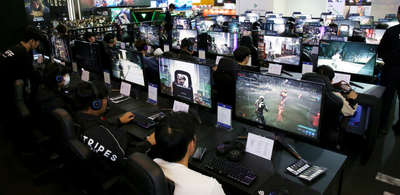 Gamers immerse themselves in LLL, NCSoft's shooting game in development that fuses high-octane action with role playing, showcased at the exhibition. (NCSoft)
