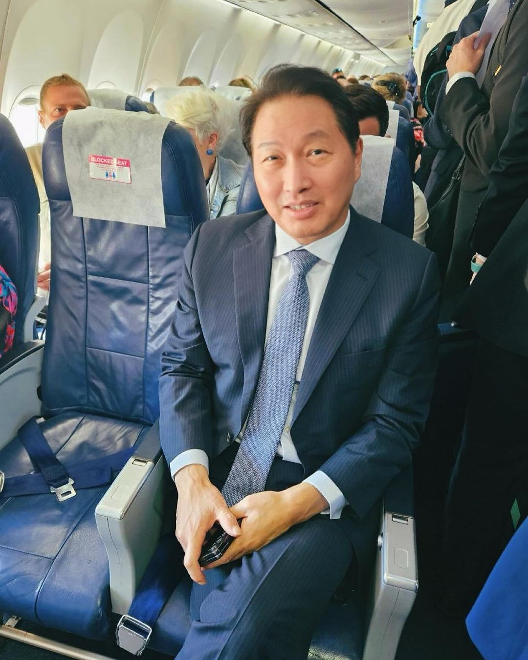 SK Group Chairman Chey Tae-won on Thursday posted a photo of him flying economy during his international campaign for Busan's Expo bid in November. (Chey Tae-won's official Instagram)