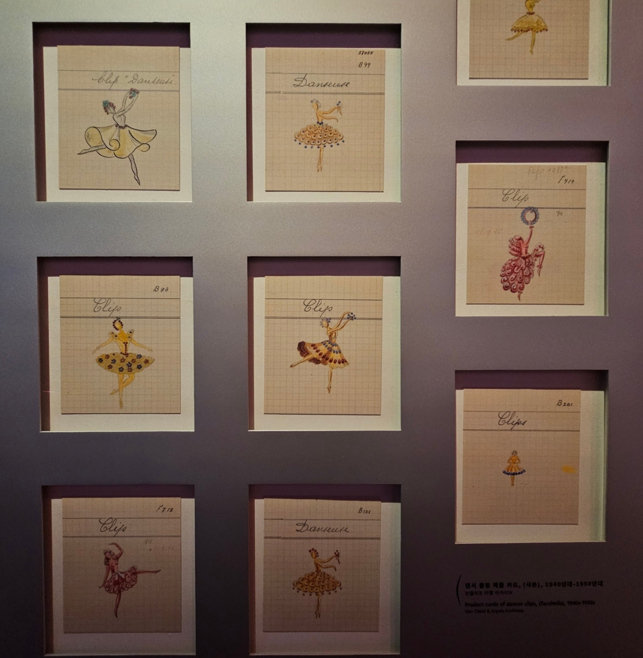 Product cards of dancer clips from the 1940s to 1950s are shown at “Van Cleef & Arpels: Time, Nature, Love