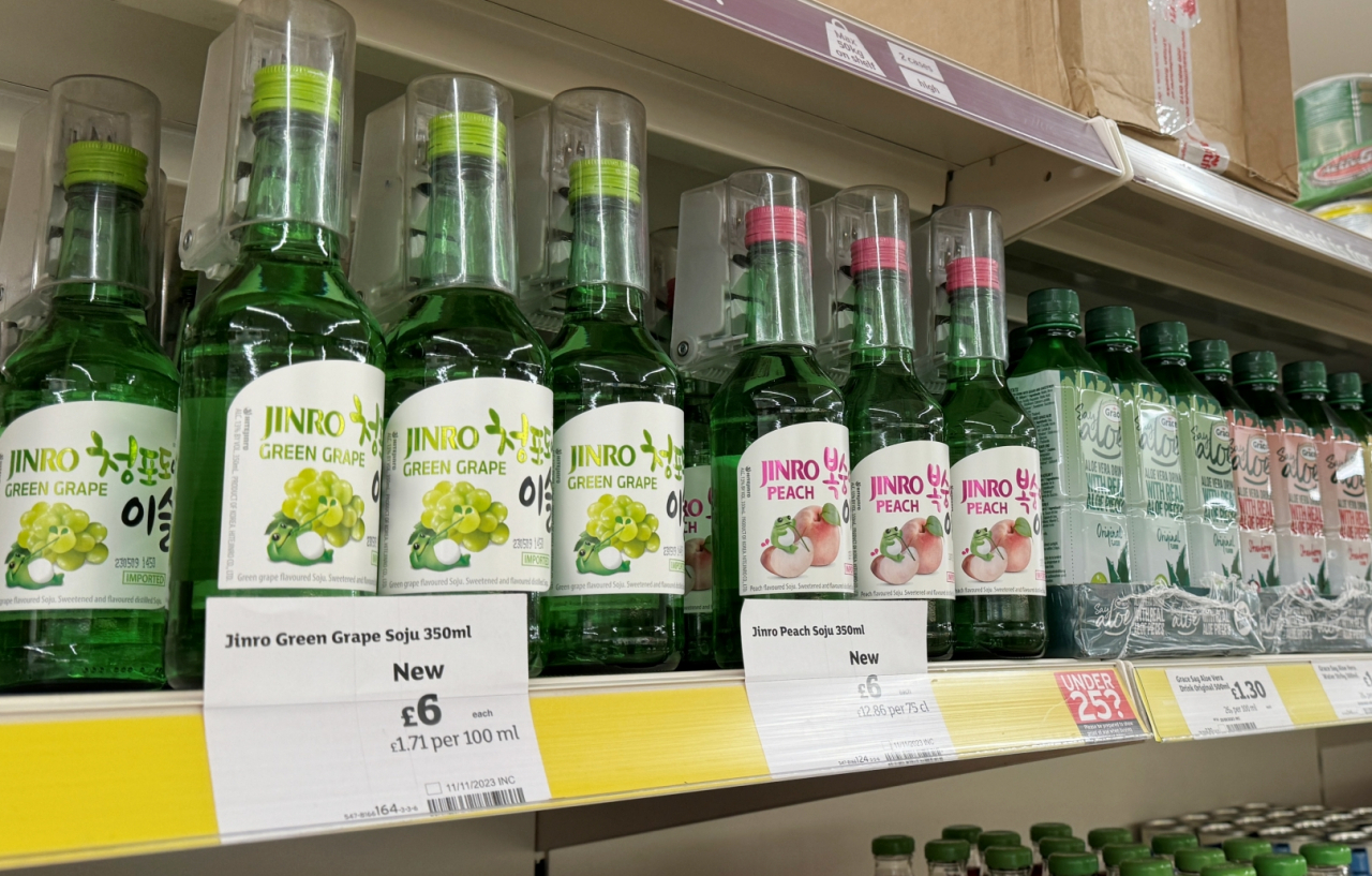 Bottles of HiteJinro's Jinro Green Grape Soju and Jinro Peach Soju are on display at a Sainsbury's store in the UK. (HiteJinro)