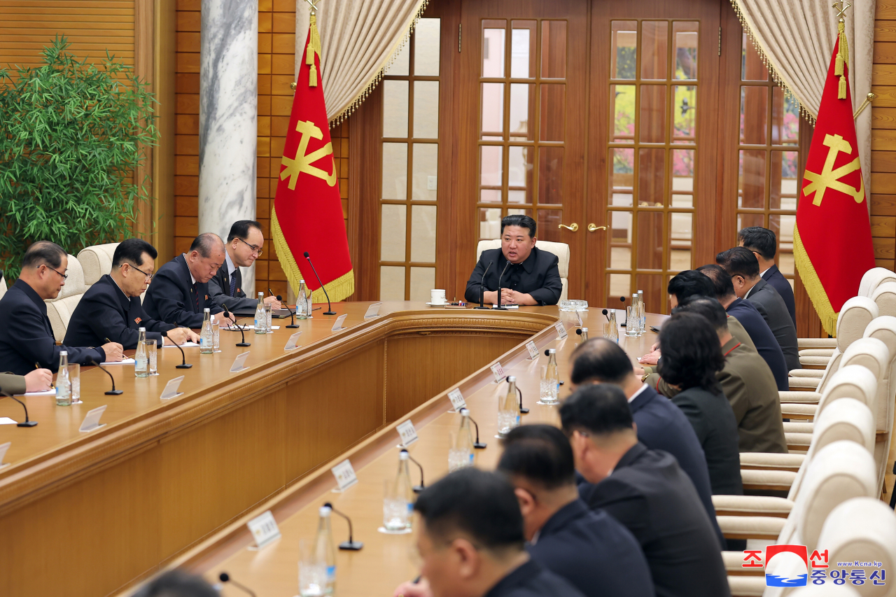 North Korean leader Kim Jong-un (5th from L) holds a politburo meeting of the Workers' Party Central Committee with his top officials in Pyongyang, on Friday, in this photo released the following day by the Korean Central News Agency. (Yonhap)