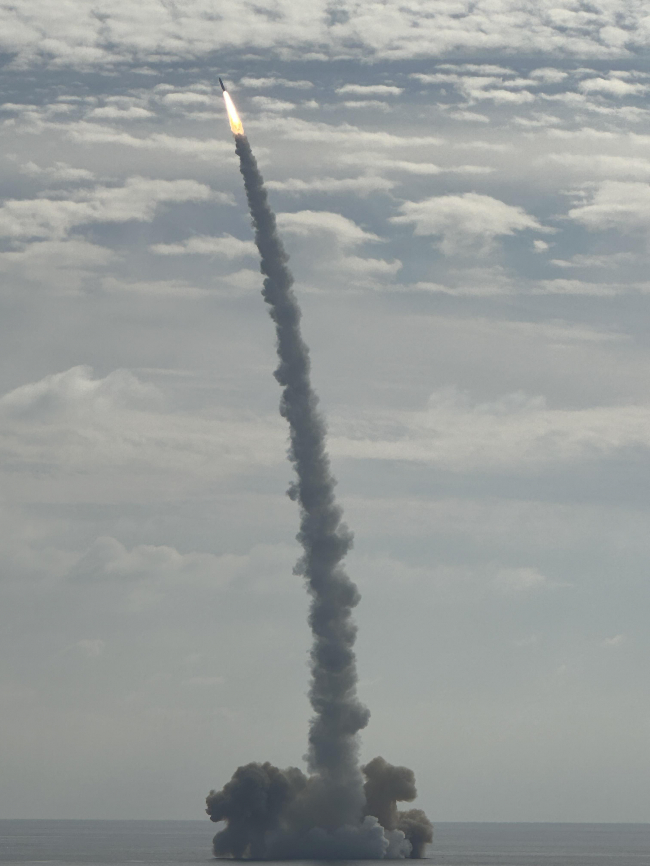 A solid-fuel space launch vehicle developed by the state-run Agency for Defense Development and equipped with a small satellite manufactured by Hanwha Systems takes off from a barge in waters off Jeju Island on Monday afternoon. (Hanwha Systems)