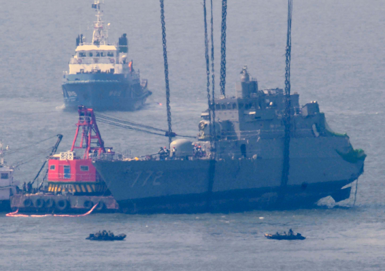The front half of South Korean naval ship Cheonan is lifted from waters near Baengnyeong Island, South Korea, on April 24, 2010. The 1,200-ton Cheonan was ripped in two in an unexplained explosion and sank on March 26, taking more than 40 lives. The Korea Herald