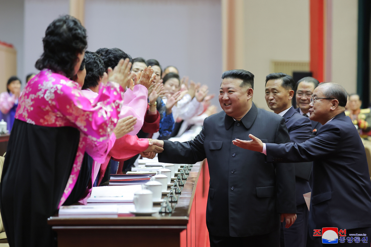 North Korean leader Kim Jong-un shakes hands with participants at the closing ceremony of the 5th National Conference of Mothers in Pyongyang on Monday, in this photo released by the state-run Korean Central News Agency. (Yonhap)