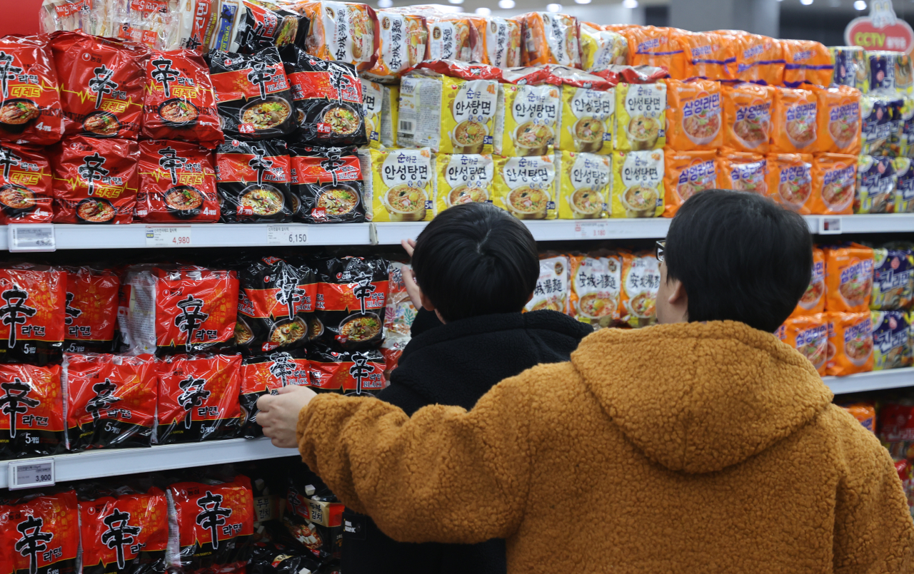 Customers are at a ramyeon section at a local discount store in Seoul, Sunday. (Yonhap)