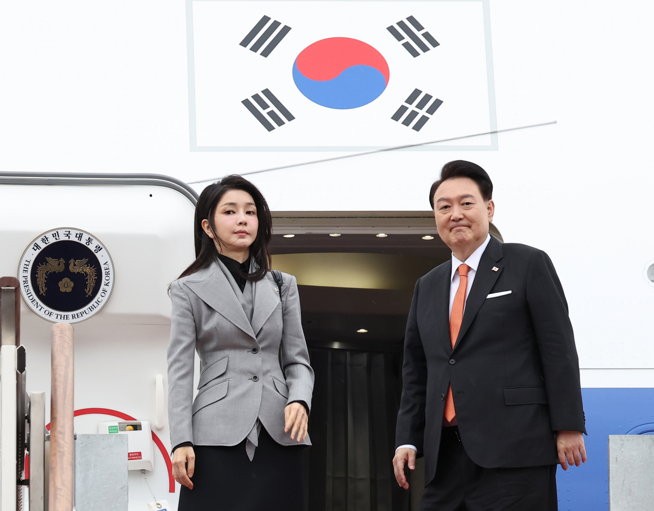 President Yoon Suk Yeol (right) and first lady Kim Keon Hee embark on Air Force One, as the couple departed Seoul Air Base in Seongnam, Gyeonggi Province, to fly to the Netherlands for a state visit on Monday. (Yonhap)