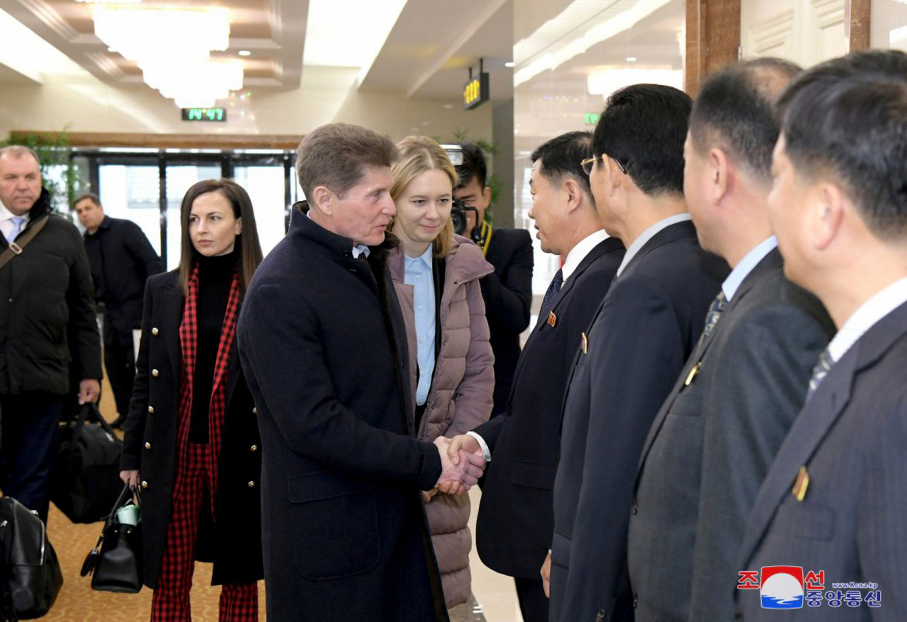 Oleg Kozhemyako (left from center), governor of the Russian far eastern region of Primorsky Krai that borders North Korea, shakes hands with North Korean officials during his visit to Pyongyang on Tuesday. (KCNA)