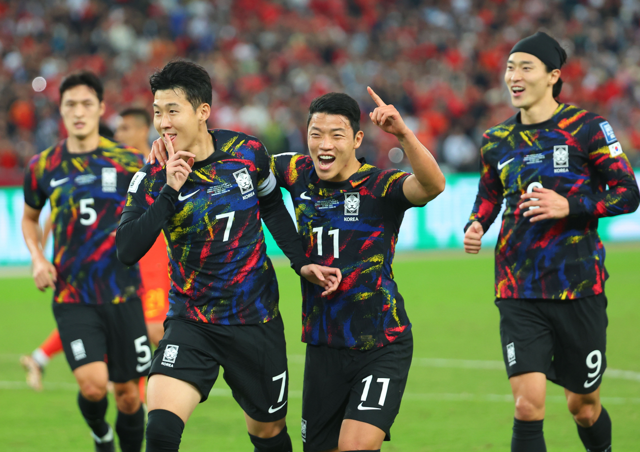 Son Heung-min of South Korea (left) celebrates after scoring against China during the teams' Group C match in the second round of the Asian World Cup qualification tournament at Shenzhen Universiade Sports Centre in Shenzhen, China. (Yonhap)
