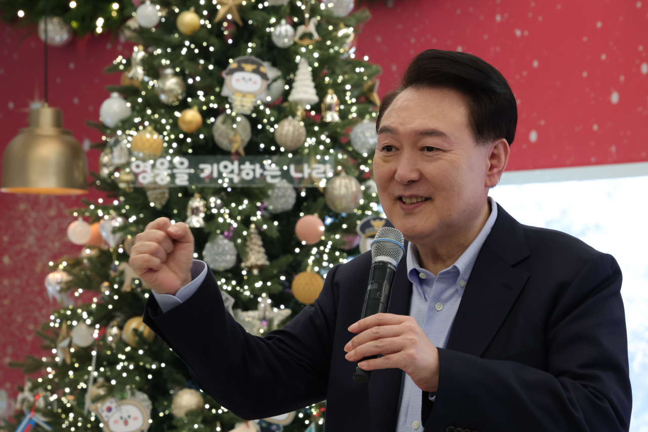 President Yoon Suk Yeol speaks during a pre-Christmas event for the family members of late soldiers, police and firefighters who died on duty, in this photo provided by the presidential office on Friday. (Yonhap)