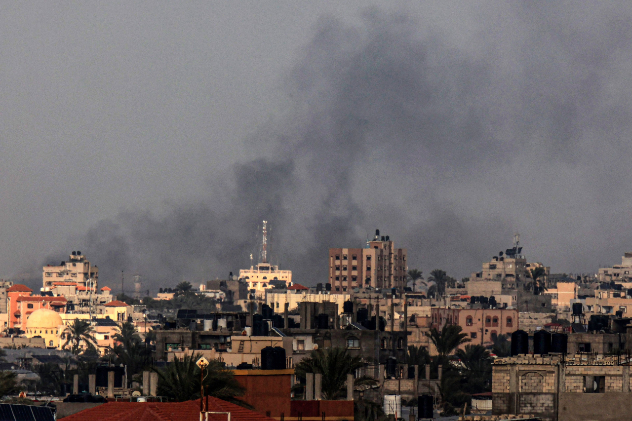 A picture taken from Rafah shows smoke billowing over Khan Yunis during Israeli bombardment of the southern Gaza Strip, on Sunday. (AFP-Yonhap)