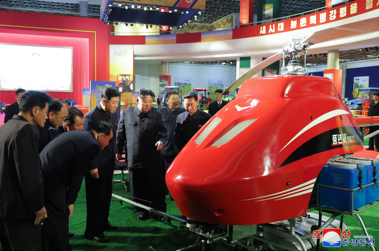 North Korean leader Kim Jong-un (center) visits an exhibition on farm machines, 