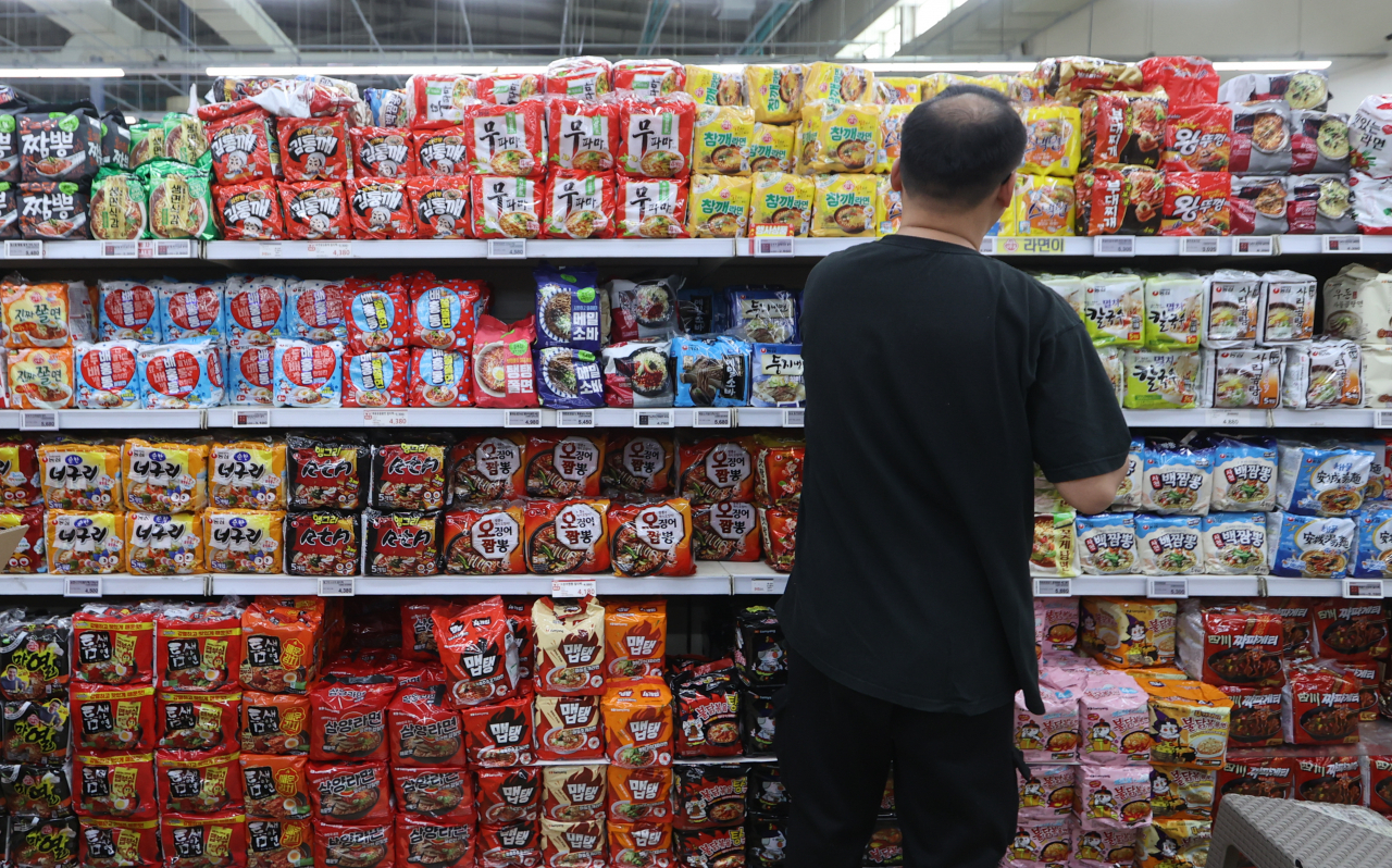 A person is seen shopping for instant noodles at a store in Seoul in this Dec. 10 photo. (Yonhap)