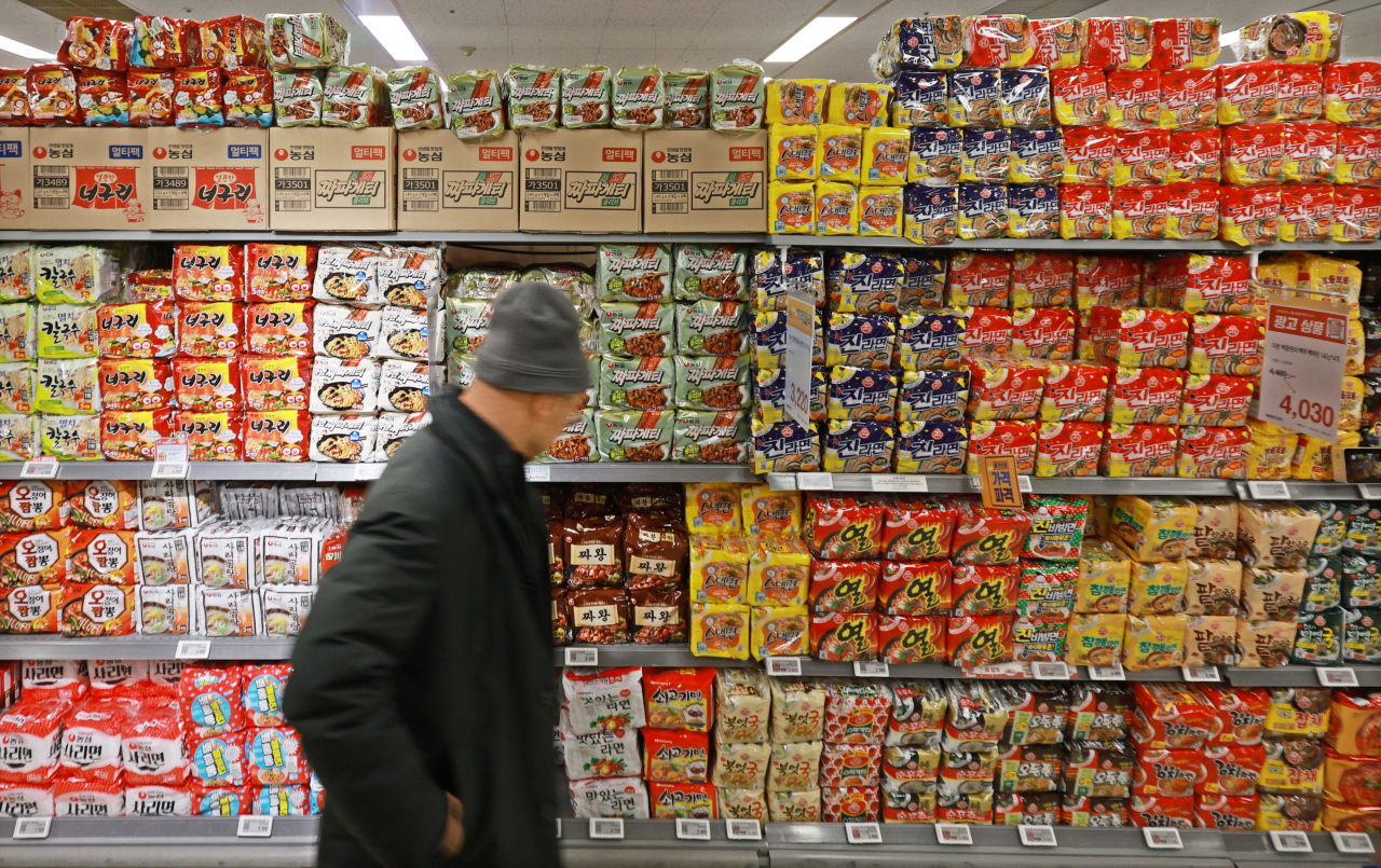 A customer shops at a ramyeon section at a local discount store in Seoul, Sunday. (Yonhap)