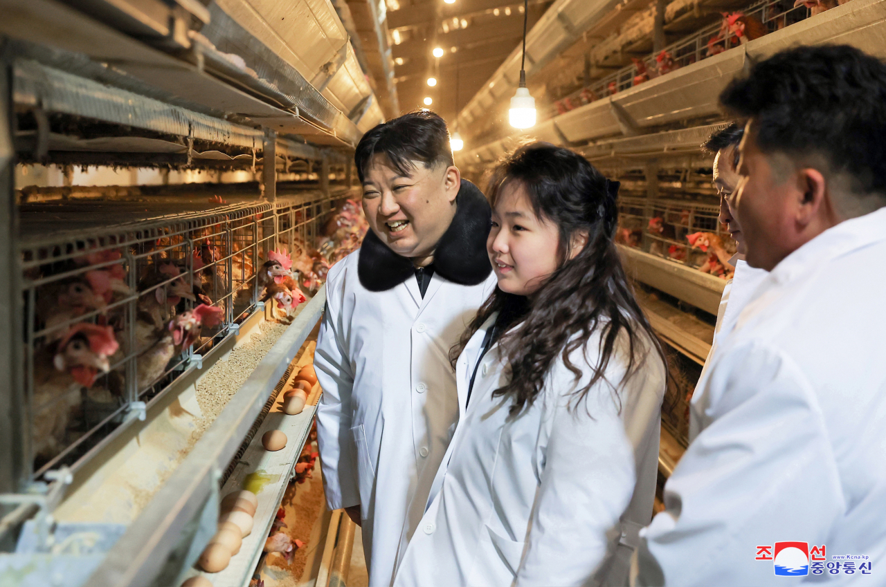 This photo, on Monday, shows the North's leaders Kim Jong-un (Left) and his daughter, known as Ju-ae, visiting Kwangchon Chicken Farm in Hwangju County of North Hwanghae Povince on Sunday. (KCNA)