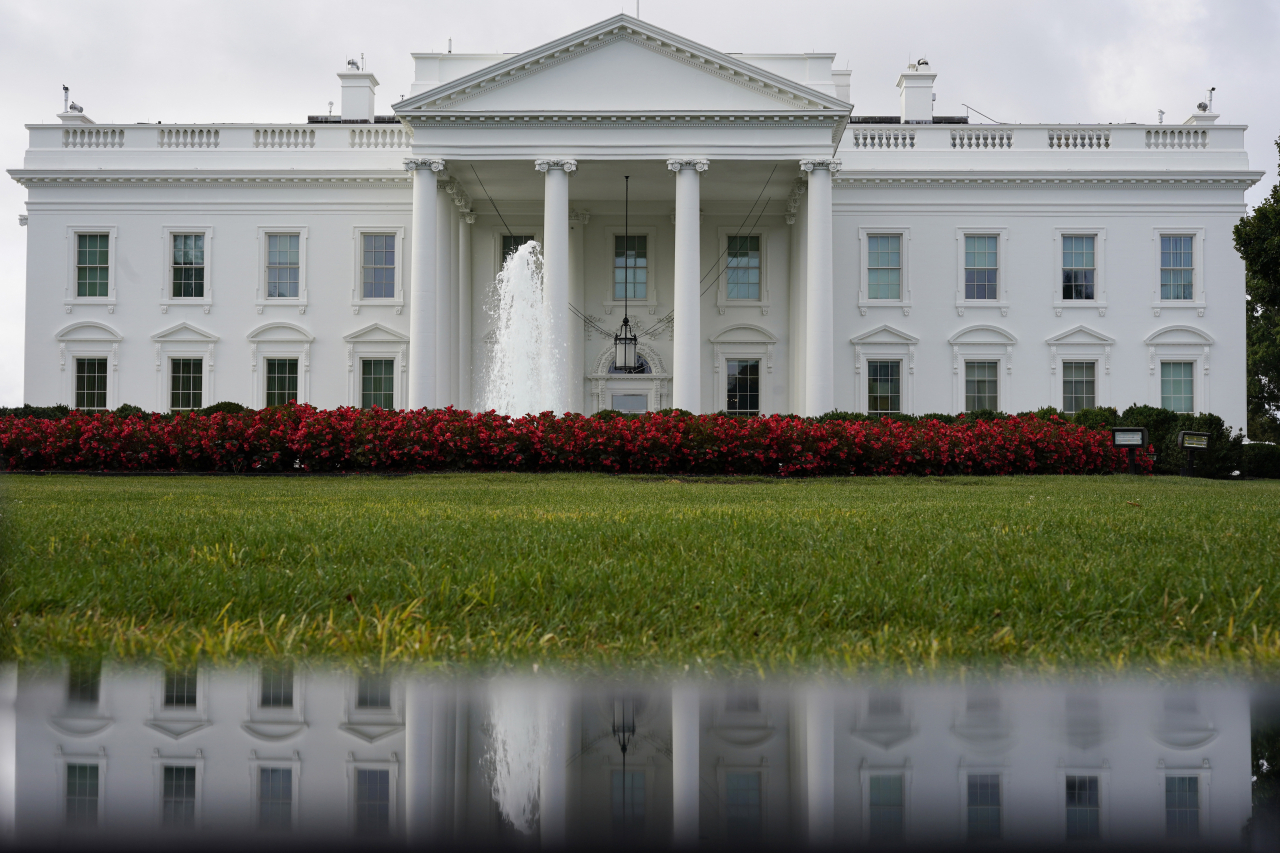 The White House is seen reflected in a puddle, Saturday, Sept. 3, 2022, in Washington. (AP)