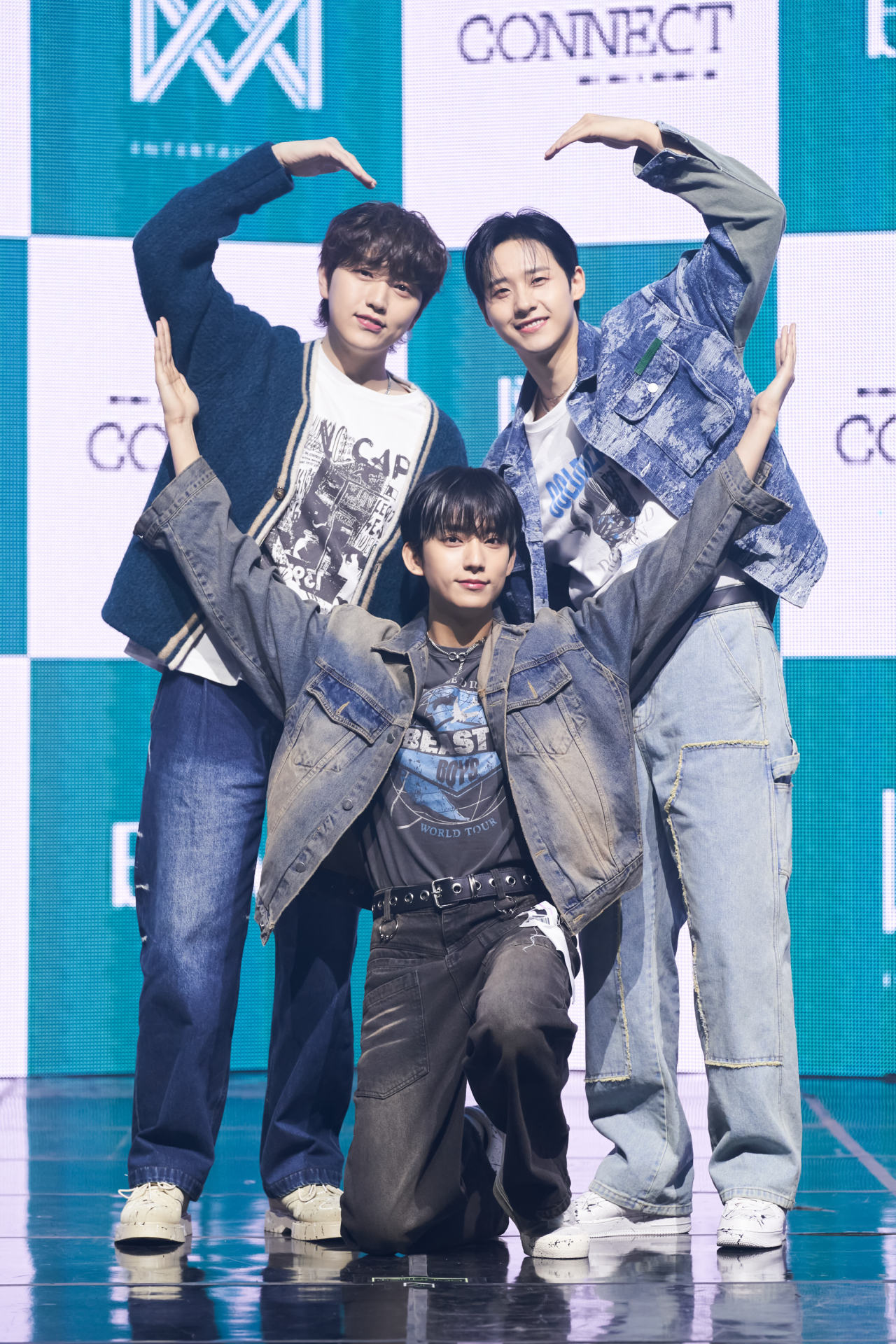 From left: B1A4 member Sandeul, Gongchan and CNU pose for pictures at a press showcase held Monday. (WM Entertainment)