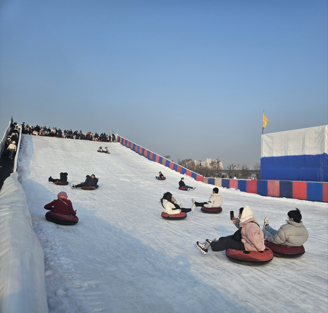 People enjoy sledding at Yeouido Hangang Park on Wednesday. (Park Yuna/The Korea Herald)