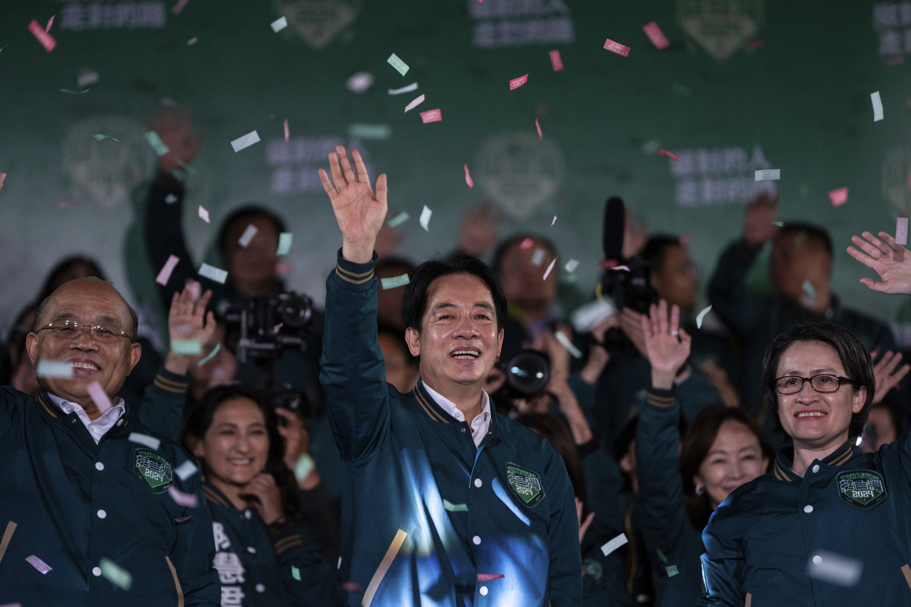 Taiwanese Vice President Lai Ching-te, also known as William Lai, left, celebrates his victory with running mate Bi-khim Hsiao in Taipei, Taiwan, Saturday. The Ruling-party candidate has emerged victorious in Taiwan's presidential election and his opponents have conceded. (AP-Yonhap)