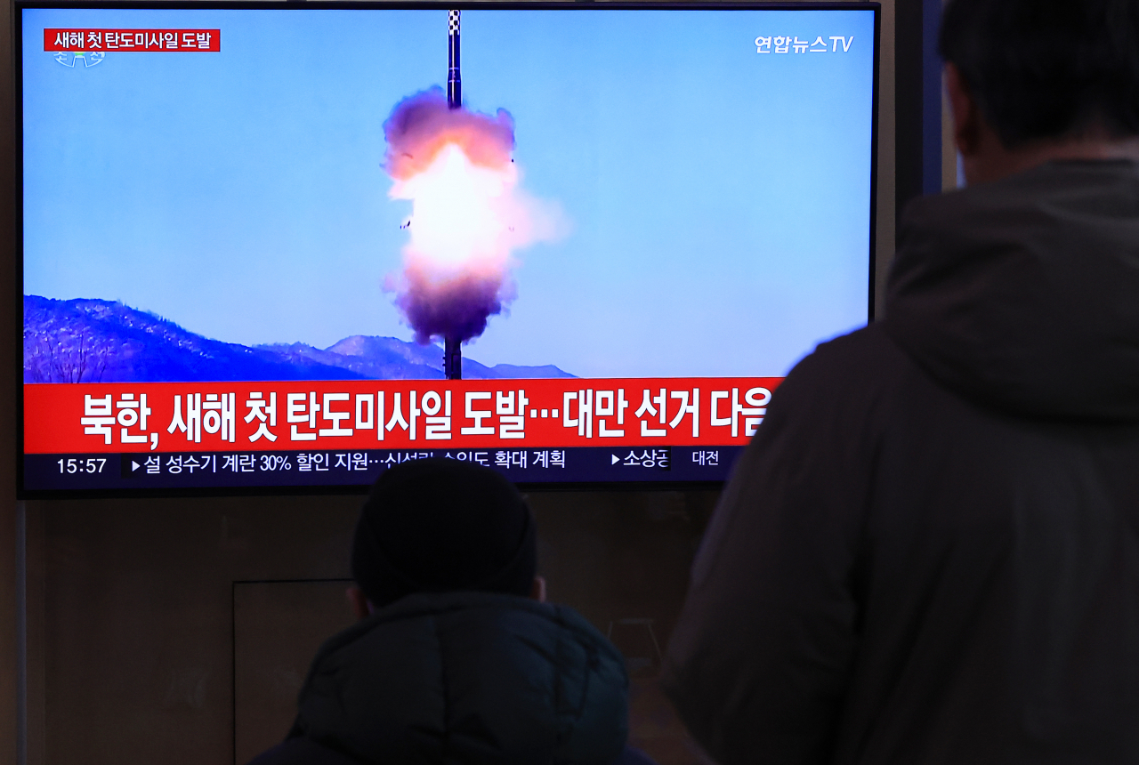 People watch a TV report at Seoul Station in the capital on Sunday, on North Korea's firing of an intermediate-range ballistic missile into the East Sea earlier in the day in its first ballistic missile launch in 2024. (Yonhap)