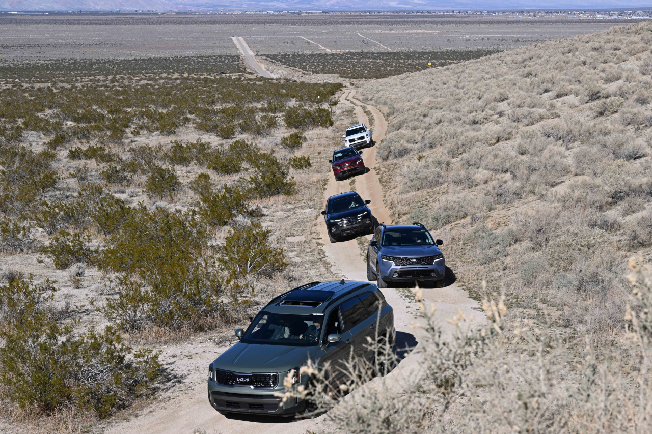 A convoy of Hyundai and Kia SUVs, led by the Kia Telluride, navigates the terrain of the California Proving Ground in the Mojave Desert. (Hyundai Motor Group)