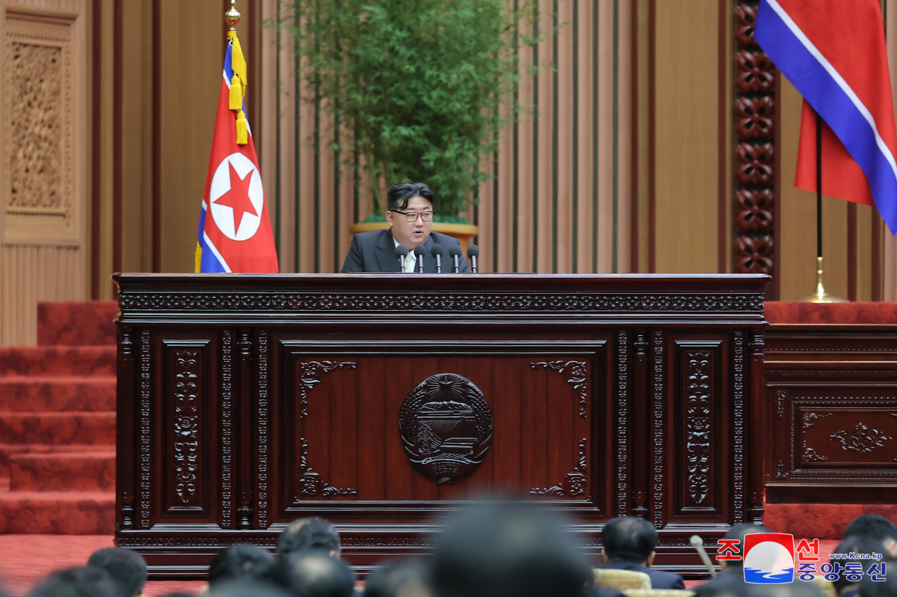 This photo, carried by North Korea's official Korean Central News Agency on Tuesday, shows the North Korean leader Kim Jong-un delivering a speech at the 10th session of the 14th Supreme People's Assembly held in Pyongyang on Monday. (Yonhap)