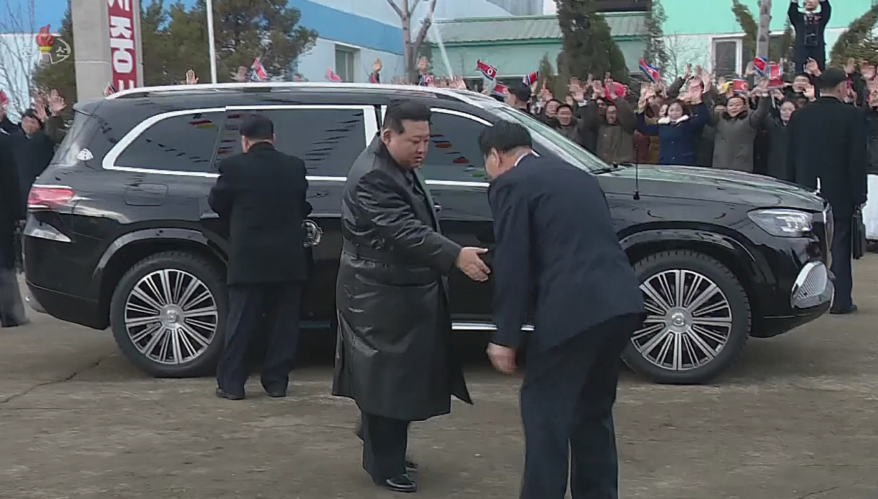 Kim Jong-un (center) gets out of a black SUV in a screenshot captured from a North Korean documentary video released Monday. The vehicle is believed to be a Mercedes-Maybach GLS600 with the mark of the chairman of the State Affairs Commission on the center of the rear door. (Yonhap)