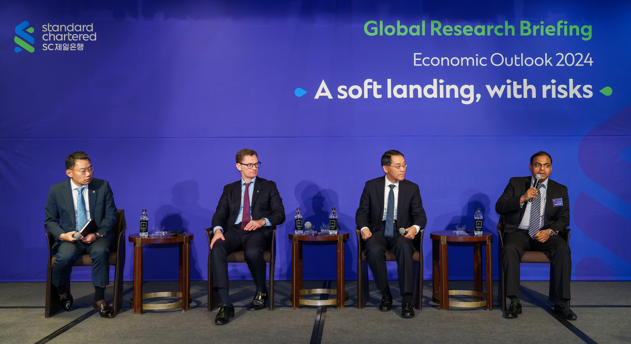 From left: Park Chong-hoon, head of research at Standard Chartered Bank Korea, Eric Robertsen, global head of research and chief strategist at Standard Chartered Bank, Ding Shuang, the banking group's managing director and chief economist, and Arup Ghosh, co-head of Asia rates research, take part in a panel discussion during the 2024 Global Research Briefing hosted by the Korean unit of the group in Seoul, Friday. (Standard Chartered Bank Korea)