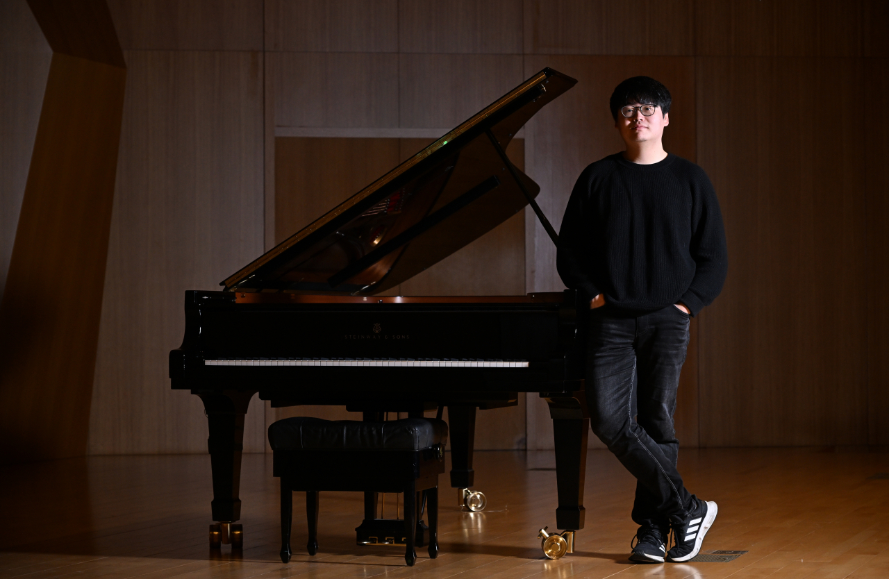 Pianist Kim Jun-hyung poses for photos during an interview with The Korea Herald on Jan. 15 at Kumho Art Hall Yonsei, Seoul. (Im Se-jun/The Korea Herald)