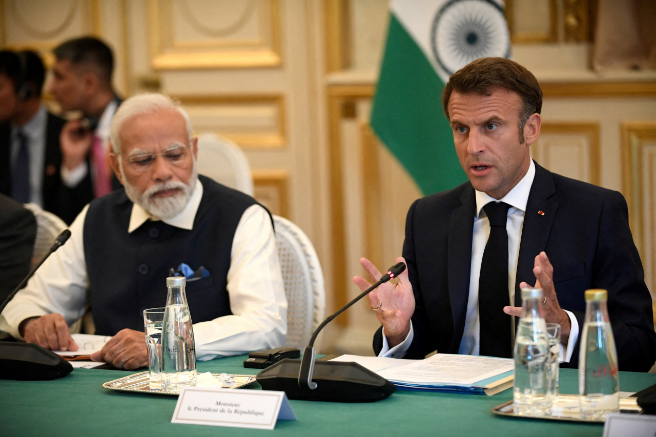 France's President Emmanuel Macron speaks as India's Prime Minister Narendra Modi listens during a meeting at The Ministry of Foreign Affairs in Paris, France on July 14, 2023. (Reuters)
