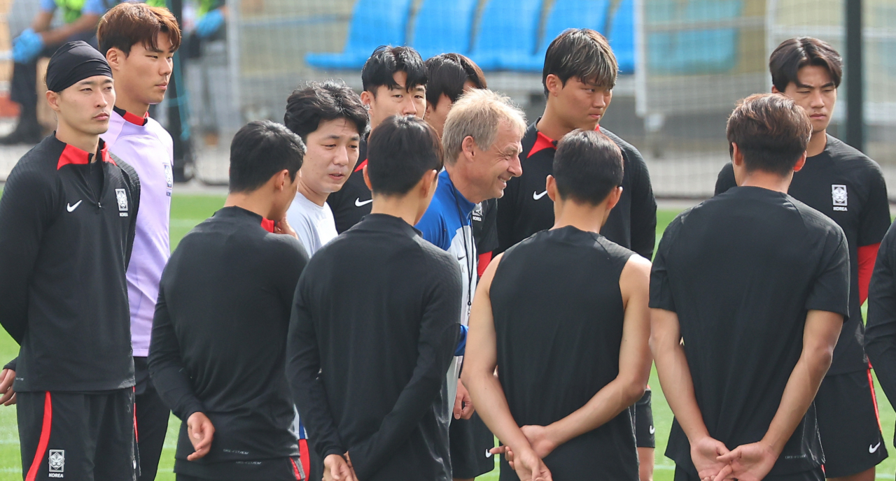 South Korean players huddle around head coach Jurgen Klinsmann (center) before a training session at Al Egla Training Site in Doha on Saturday, for the round of 16 match against Saudi Arabia at the Asian Football Confederation Asian Cup. (Yonhap)