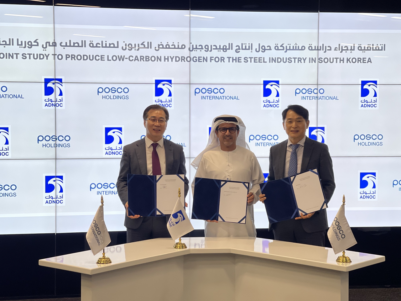 From left, - Lee Jeon-hyeok, the head of the energy business unit at Posco International, Musabbeh Al Kaabi, the executive director of Low Carbon Solutions & International Growth Directorate at ADNOC and Cho Ju-ik, the head of the hydrogen business team at Posco Holdings, pose for a photo at a signing ceremony held at ADNOC's headquarters in Abu Dhabi. (Posco International)