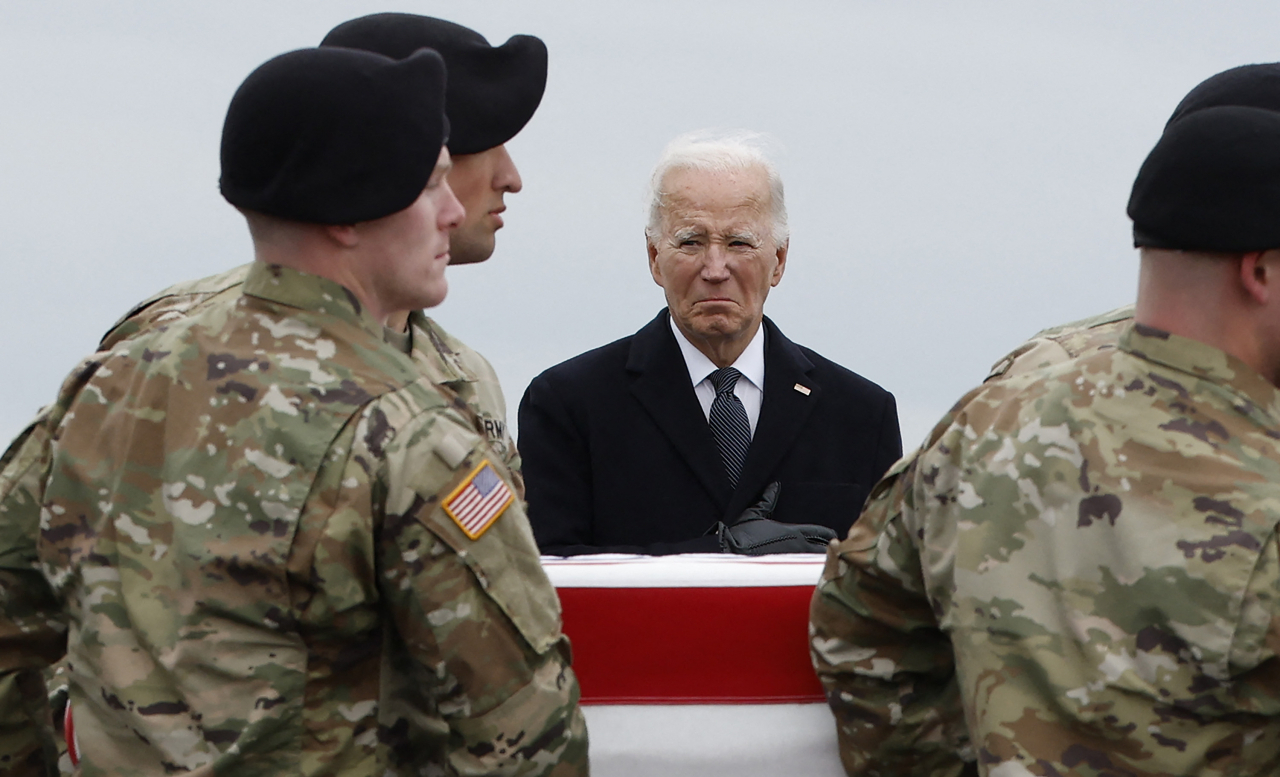 US President Joe Biden places his hand over his heart as a US Army carry team moves a flagged draped transfer case containing the remains of Army Sgt. Breonna Moffett during a dignified transfer at Dover Air Force Base, Friday in Dover, US. (Getty Images via AFP)
