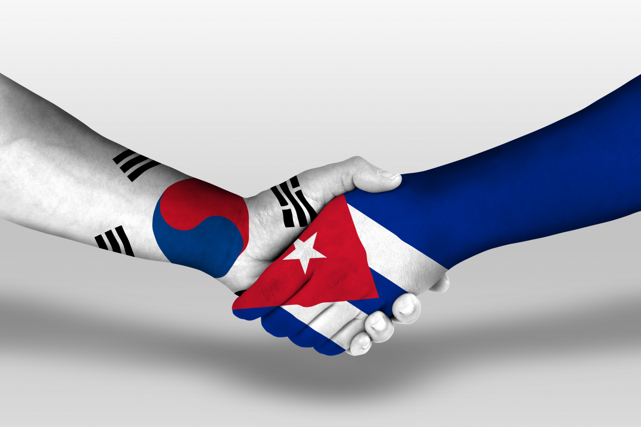 The national flags of South Korea (left) and Cuba are embedded within images of shaking hands. (123rf)