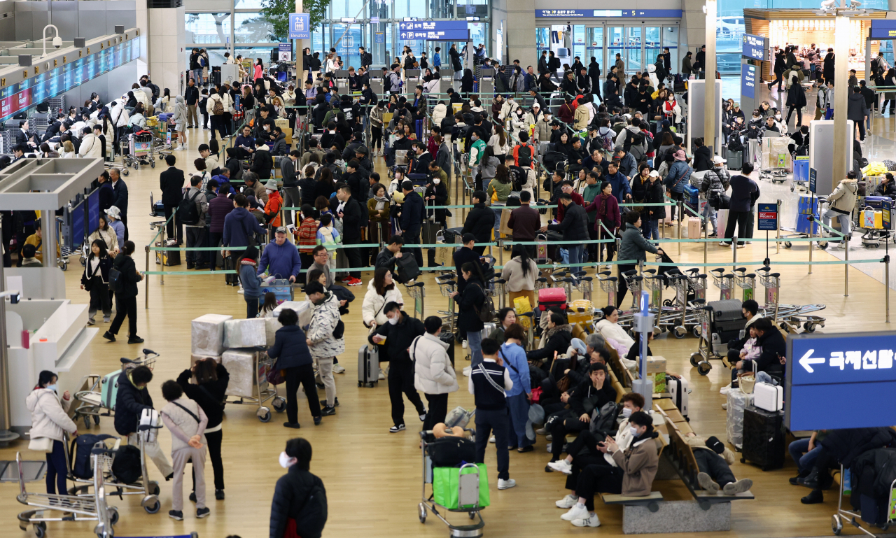 Travelers walk at the departure hall of Incheon International Airport in Incheon, west of Seoul, on Feb. 8, 2024. (Yonhap)