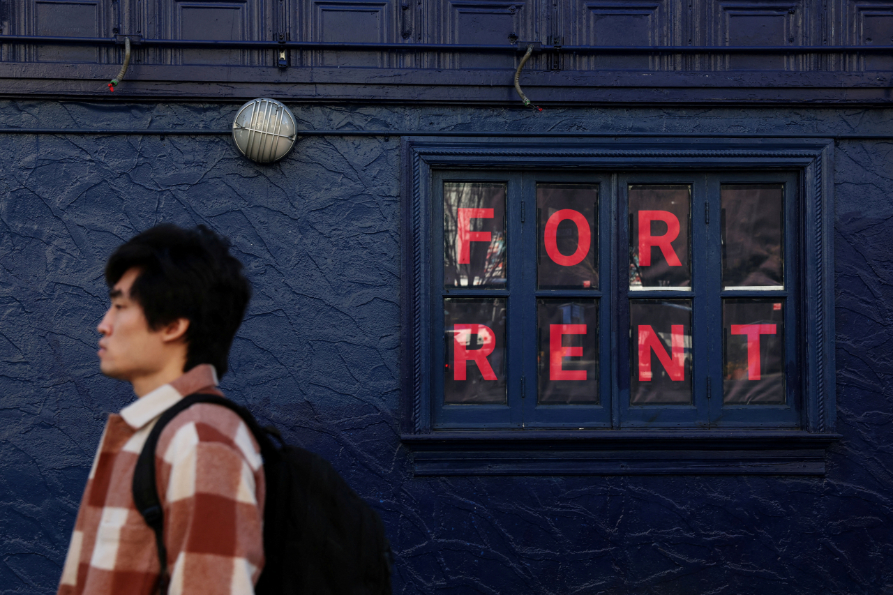 A man walks by as sign advertising real estate for rent in the SoHo area of New York City on Feb. 8. (Reuters-Yonhap)